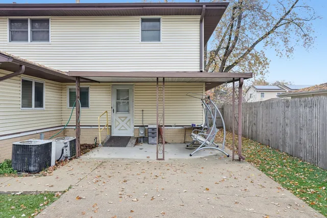 a view of a house with backyard and a tree
