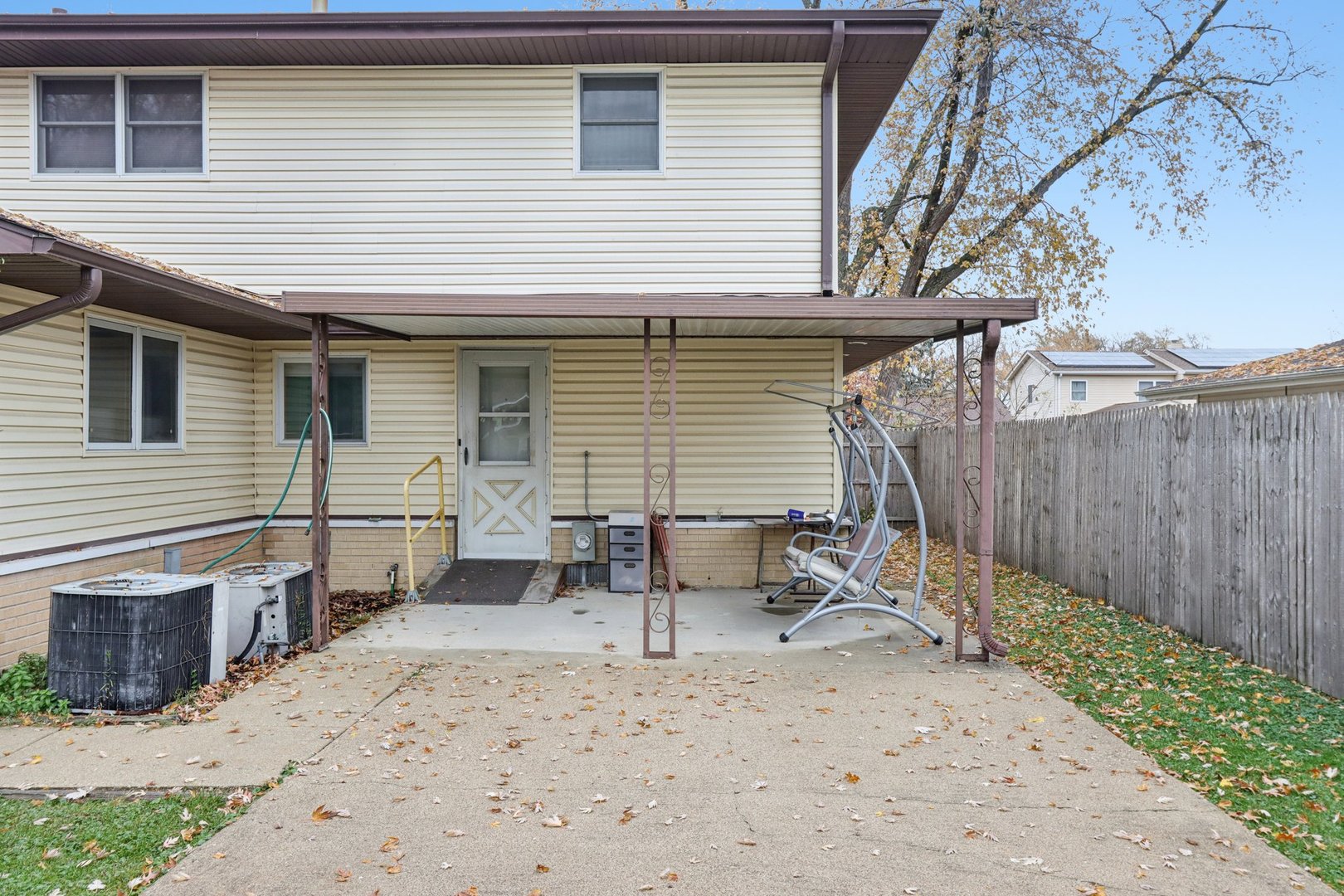 132 Tanglewood Drive Elk Grove Village, IL 60007 - Photo 35 of 42 a view of a patio with a table and chairs and wooden fence