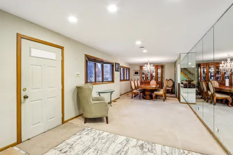 a living room with furniture and a dining table with potted plant