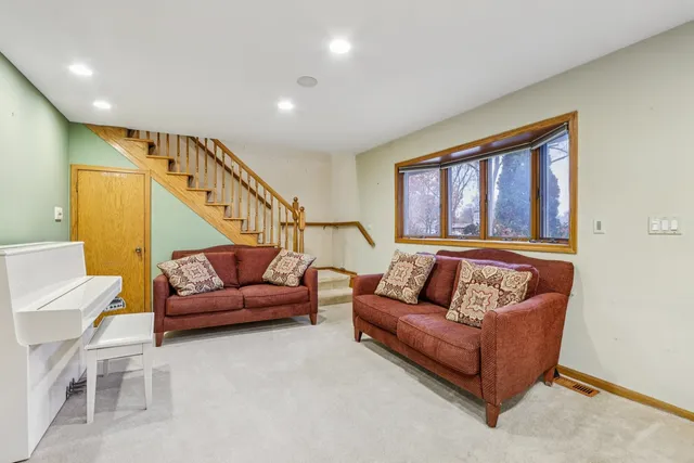 a living room with furniture and a potted plant