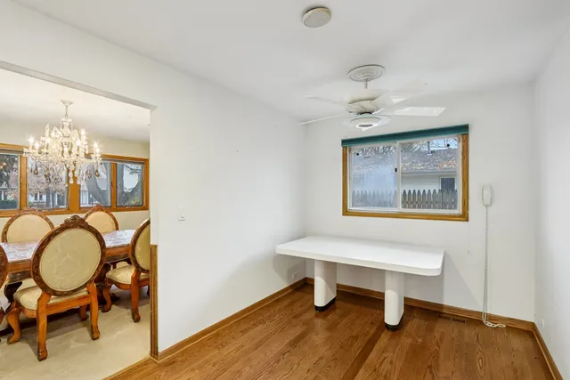 a view of a livingroom with furniture and a workspace