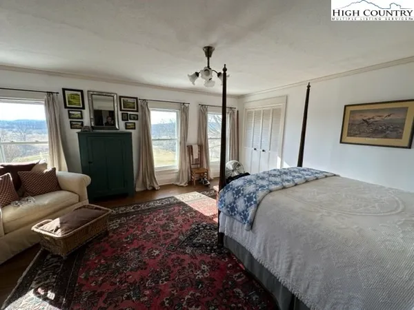a spacious bedroom with a bed and a window