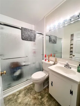 a bathroom with a sink a toilet and a mirror