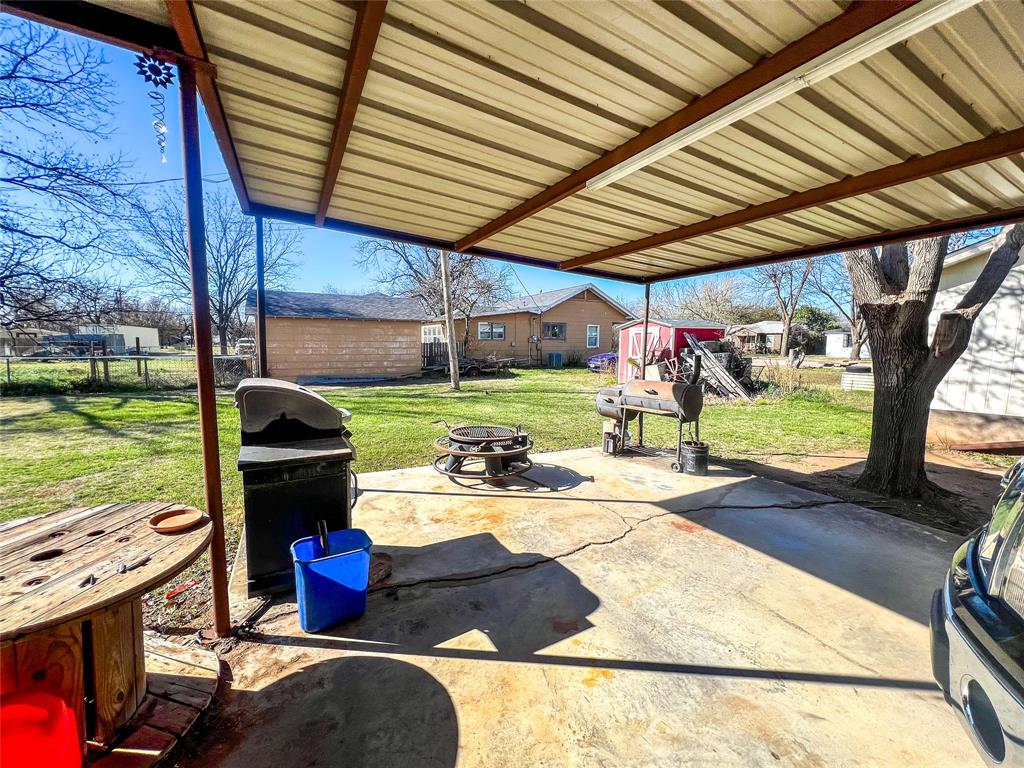 805 North 11th Street Haskell, TX 79521 - Photo 25 of 30 a view of a backyard with table and chairs and a barbeque