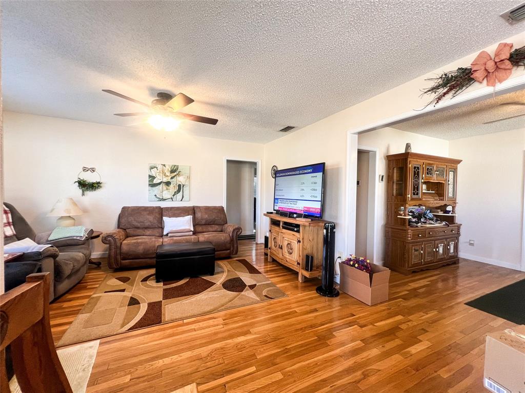 805 North 11th Street Haskell, TX 79521 - Photo 4 of 30 a living room with furniture and a flat screen tv