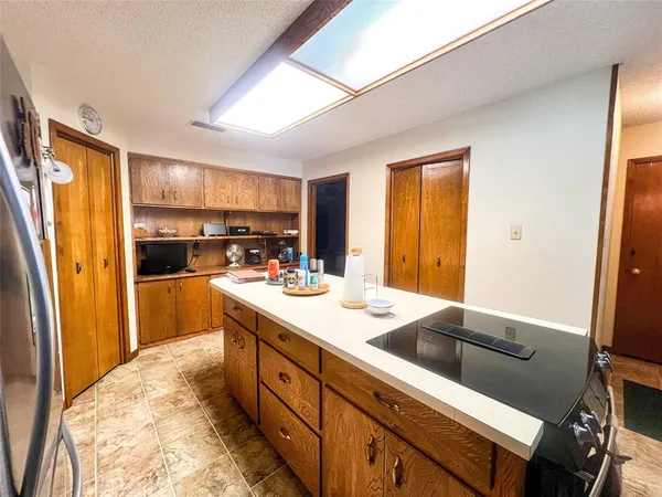 a kitchen with a refrigerator and a stove top oven