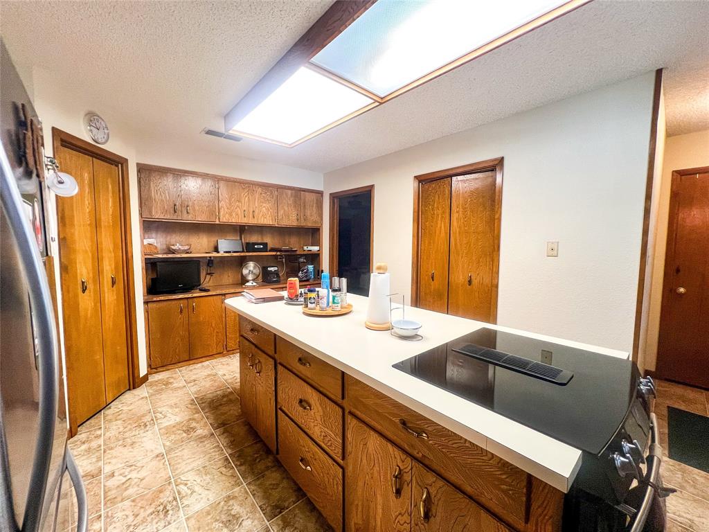805 North 11th Street Haskell, TX 79521 - Photo 8 of 30 a kitchen with a refrigerator and a stove top oven