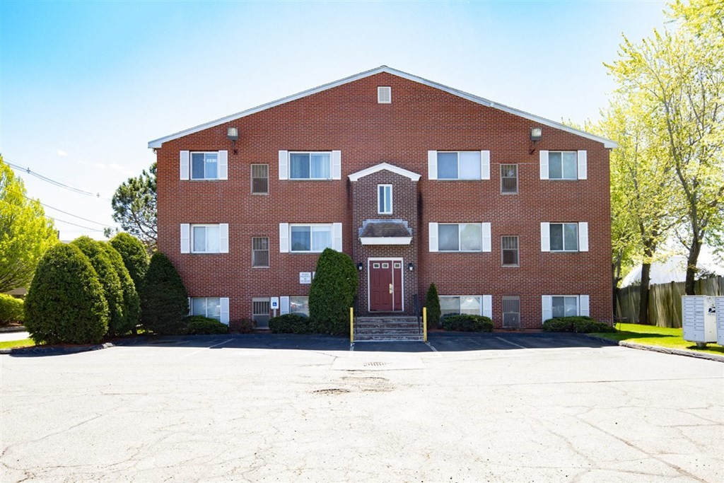 35 Prospect Street, Unit 301 Woburn, MA 01801 - Photo 18 of 19 a front view of a building with a yard