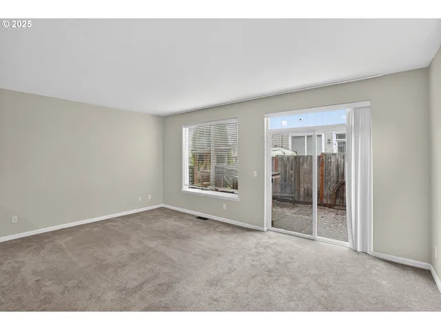 a view of an empty room with kitchen