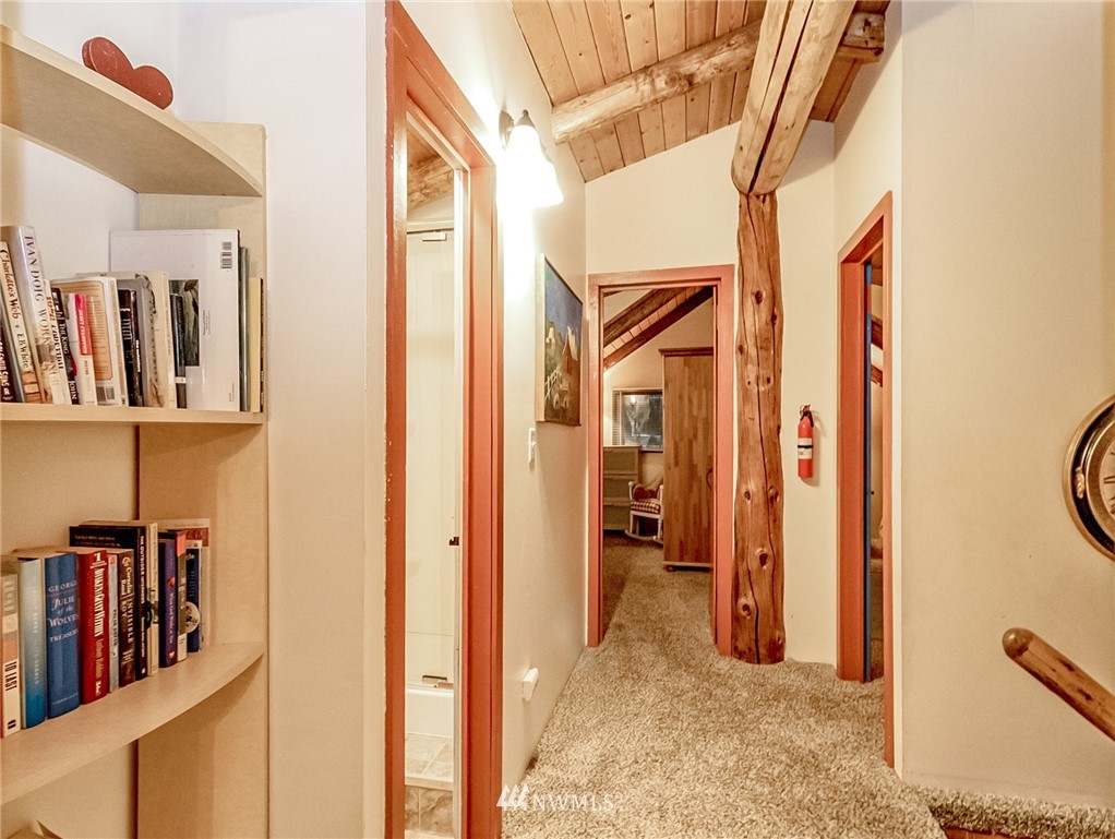 10907 Valley View Road Bothell, WA 98011 - Photo 17 of 32 a view of a hallway with wooden shelves