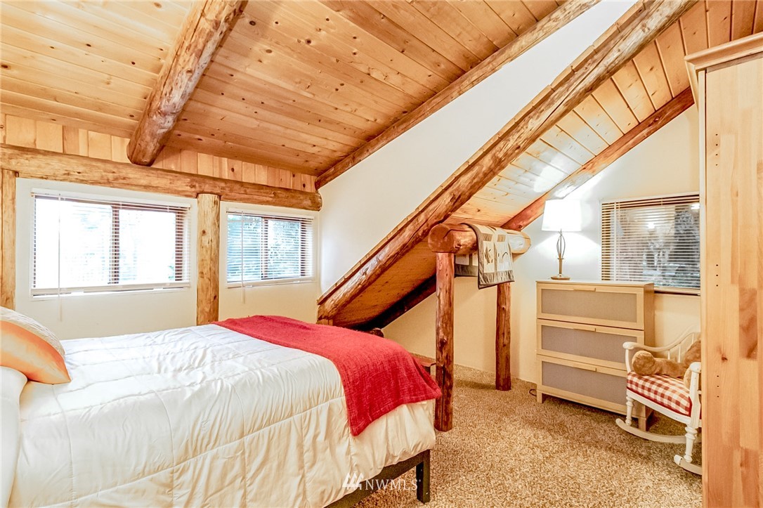 10907 Valley View Road Bothell, WA 98011 - Photo 19 of 32 a bedroom with a bed and a window
