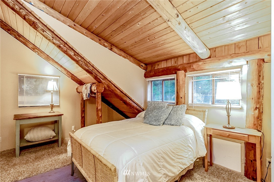 10907 Valley View Road Bothell, WA 98011 - Photo 20 of 32 a bedroom with a bed and a chair with the outer view