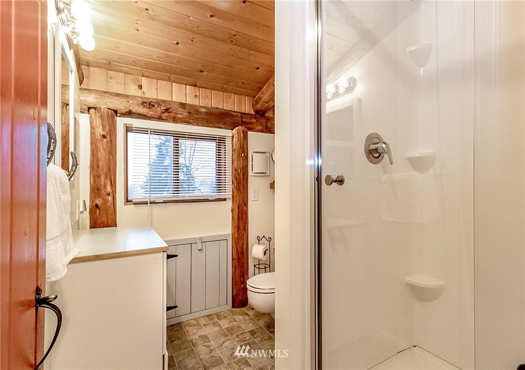 10907 Valley View Road Bothell, WA 98011 - Photo 21 of 32 a bathroom with a granite countertop sink a toilet and shower
