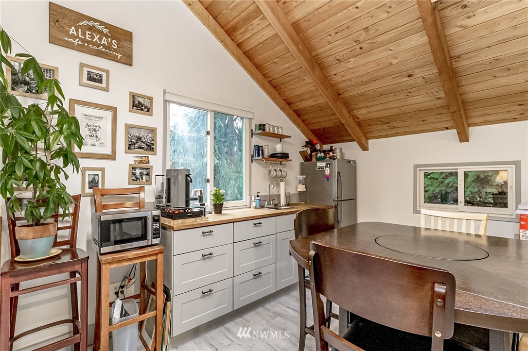 10907 Valley View Road Bothell, WA 98011 - Photo 26 of 32 a kitchen with a table chairs stove and cabinets