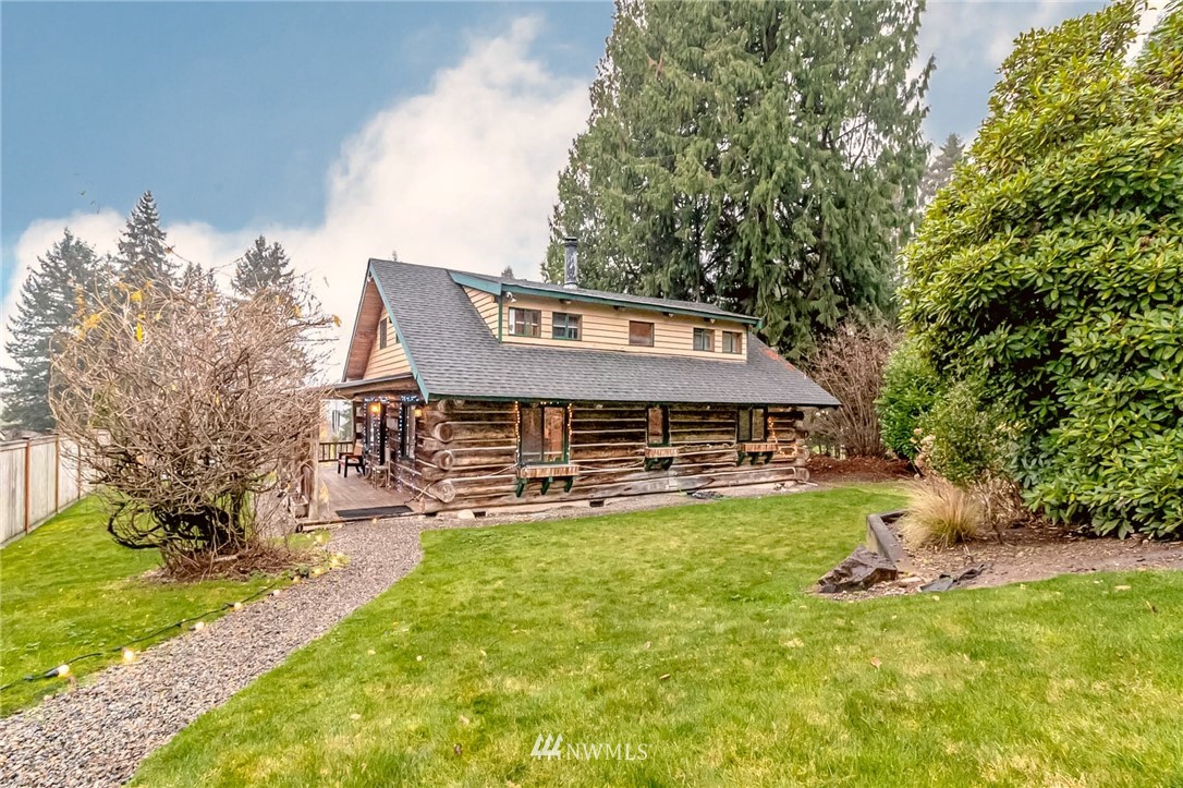 10907 Valley View Road Bothell, WA 98011 - Photo 4 of 32 a view of a house with a big yard and large trees