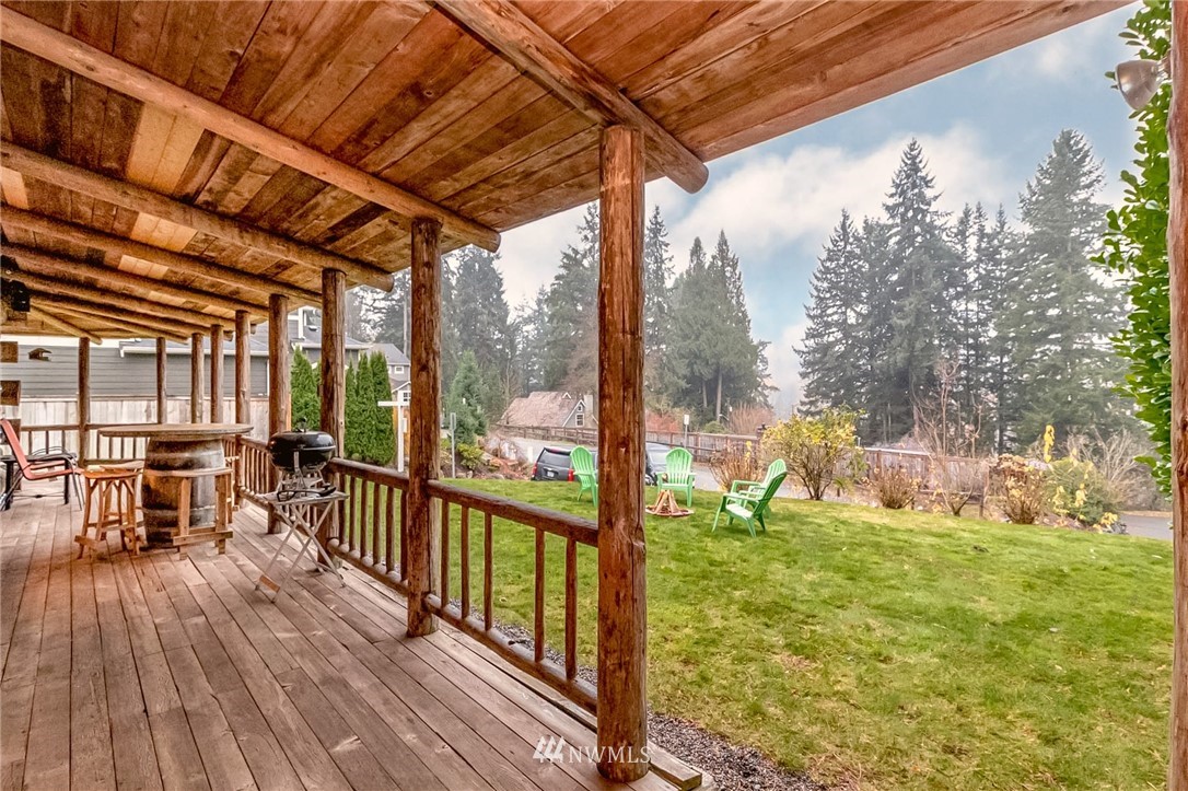 10907 Valley View Road Bothell, WA 98011 - Photo 8 of 32 a view of a porch with wooden floor and yard in the back
