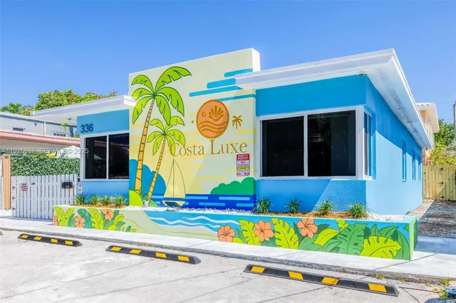 a kitchen with stainless steel appliances granite countertop a refrigerator a sink dishwasher and white cabinets with wooden floor