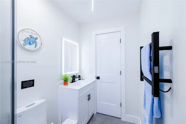 a kitchen with stainless steel appliances granite countertop a sink and a stove with wooden floor