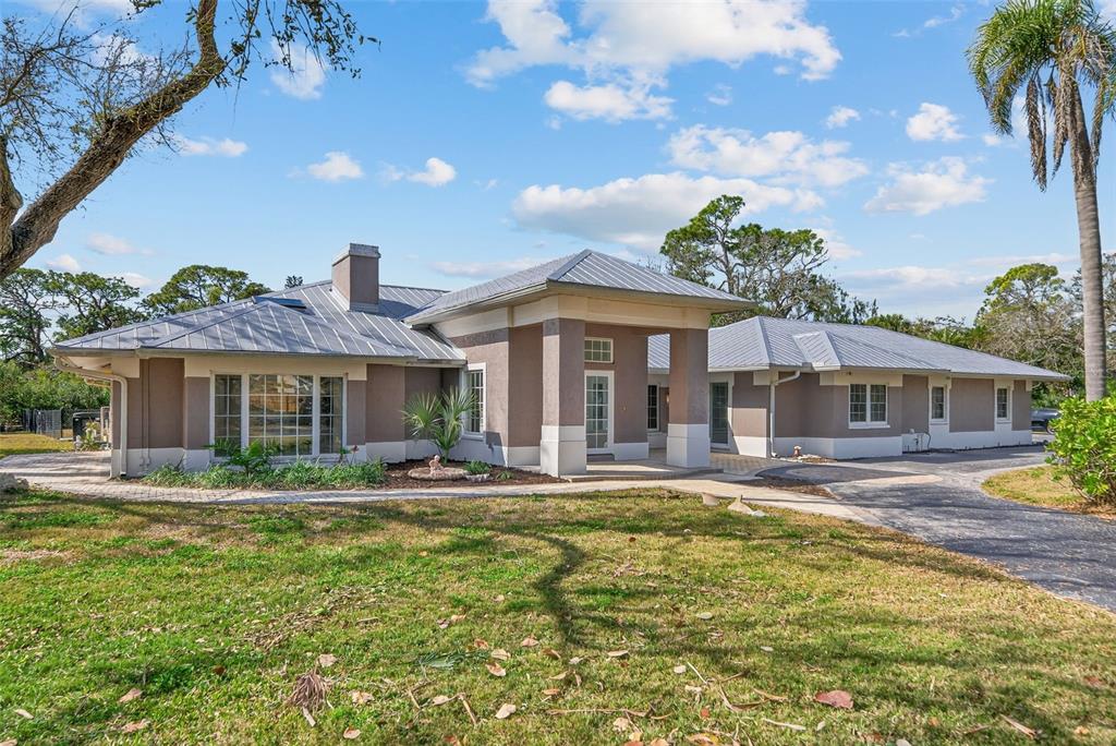 7108 Midnight Pass Road Sarasota, FL 34242 - Photo 4 of 83 a front view of a house with garden