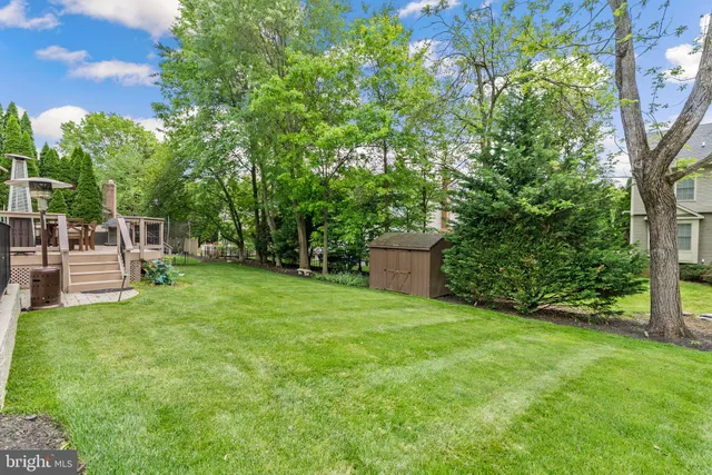 a view of a backyard with seating space