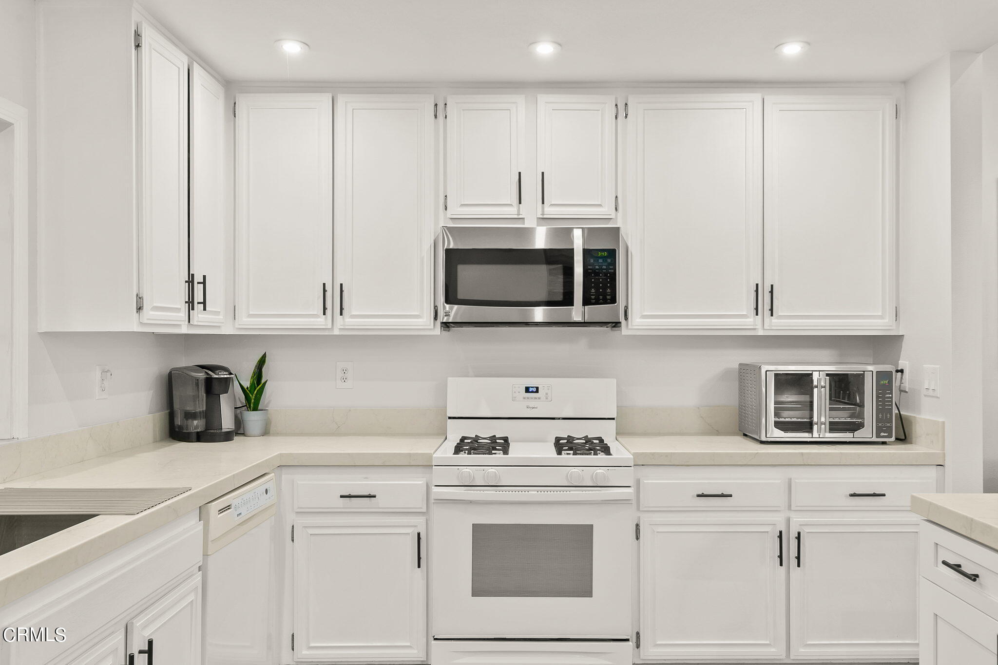 2531 Raft Lane Oxnard, CA 93035 - Photo 11 of 42 a kitchen with stainless steel appliances granite countertop white cabinets a sink and dishwasher