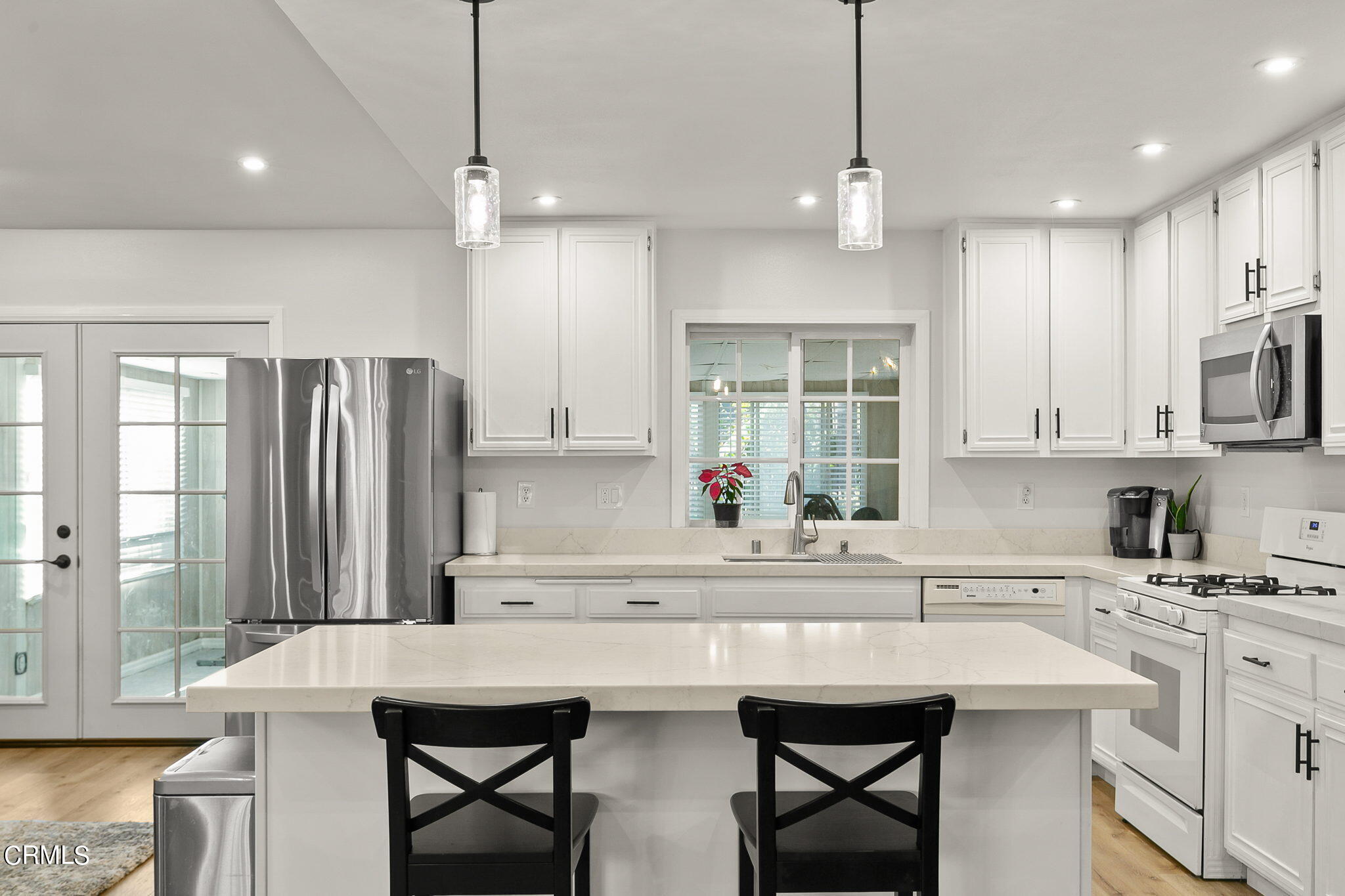 2531 Raft Lane Oxnard, CA 93035 - Photo 9 of 42 a kitchen with stainless steel appliances a sink a stove a refrigerator and island with wooden floor