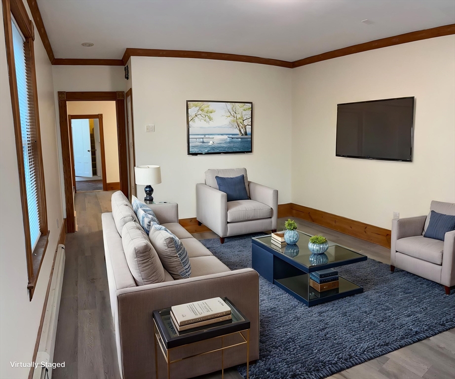 14 Gilkey Court, Unit 1 Watertown, MA 02472 - Photo 1 of 12 a living room with furniture a rug and a flat screen tv
