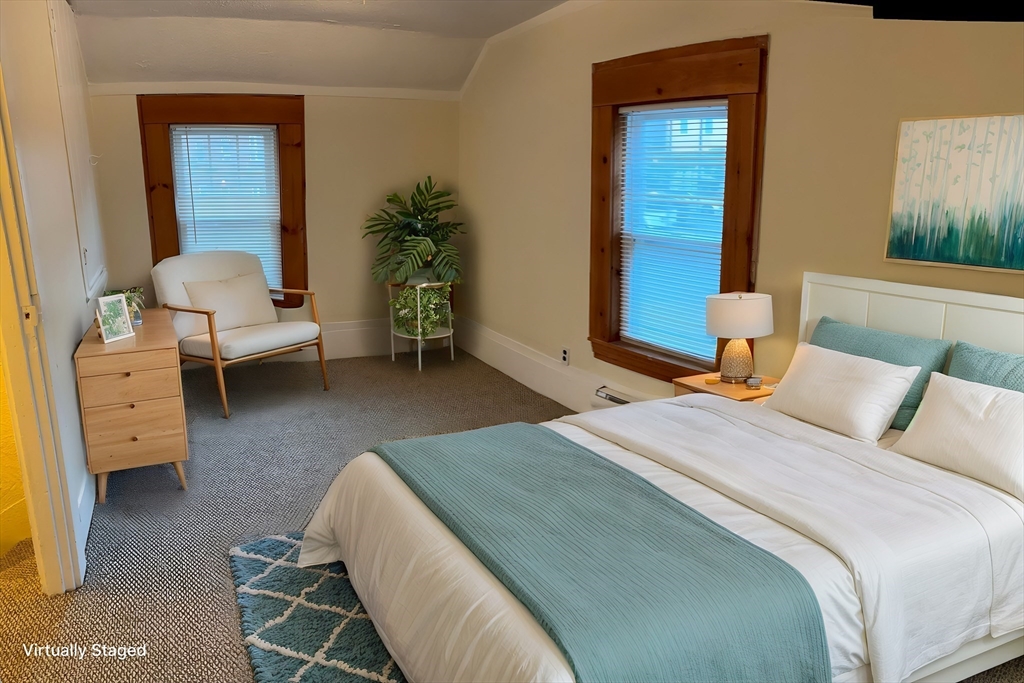 14 Gilkey Court, Unit 1 Watertown, MA 02472 - Photo 4 of 12 a bedroom with a bed and a couch