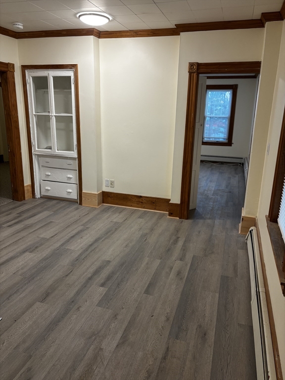 14 Gilkey Court, Unit 1 Watertown, MA 02472 - Photo 7 of 12 a view of an empty room with wooden floor and a window