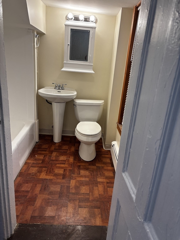 14 Gilkey Court, Unit 1 Watertown, MA 02472 - Photo 9 of 12 a bathroom with a toilet sink and mirror