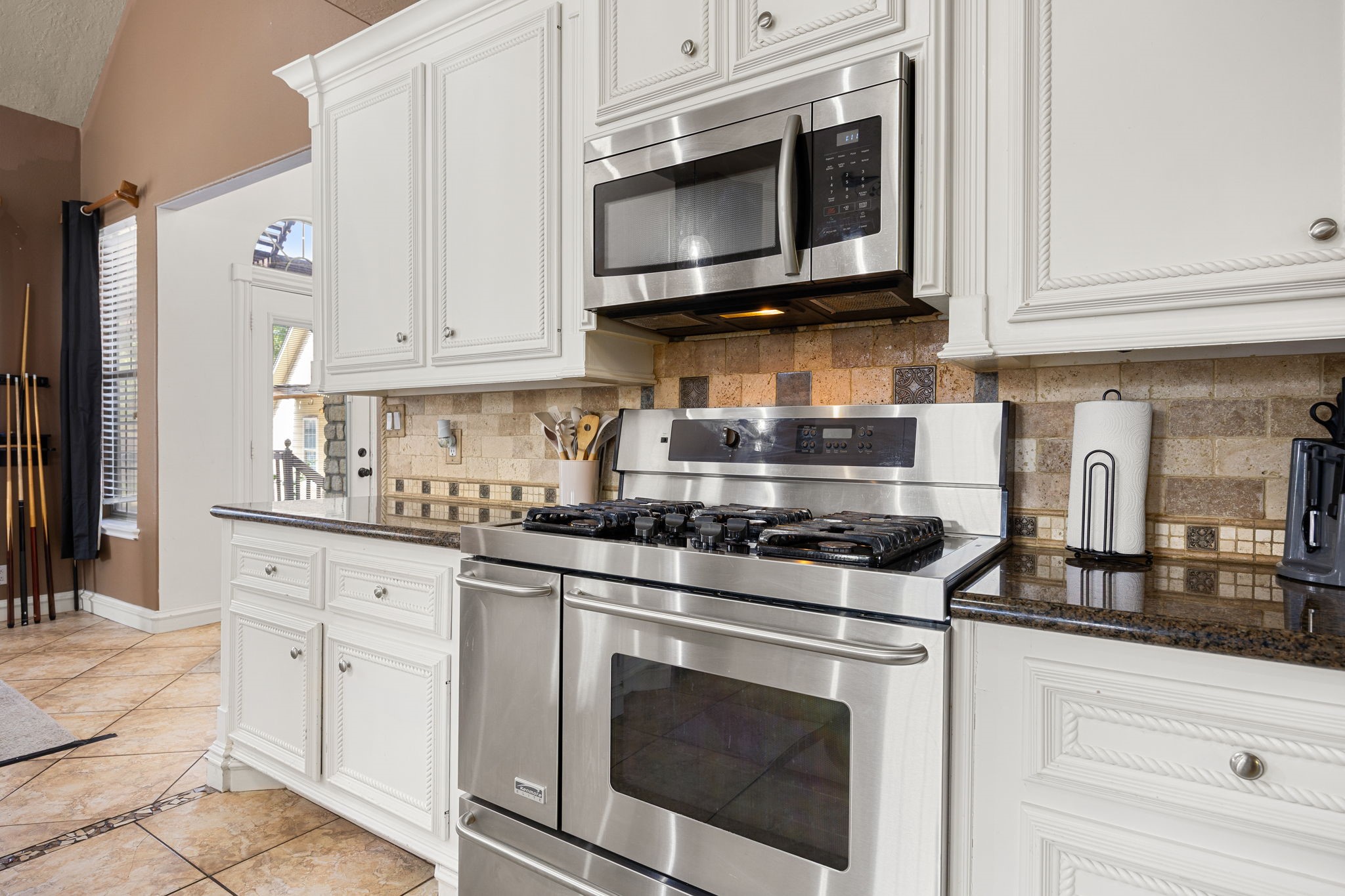 21427 Tophill Drive Spring, TX 77388 - Photo 17 of 50 a kitchen with stainless steel appliances granite countertop white cabinets a stove a sink and dishwasher
