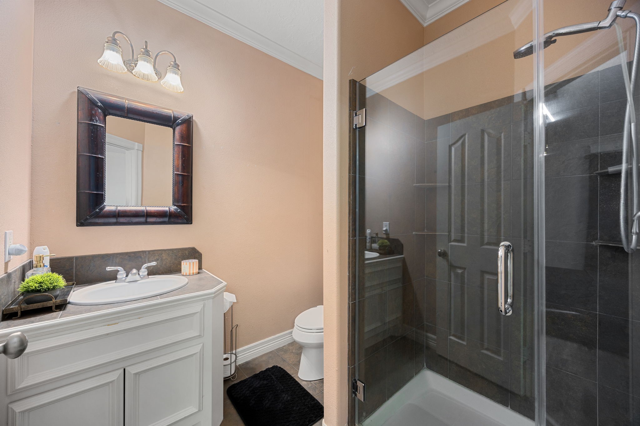 21427 Tophill Drive Spring, TX 77388 - Photo 28 of 50 a bathroom with a toilet a sink and mirror