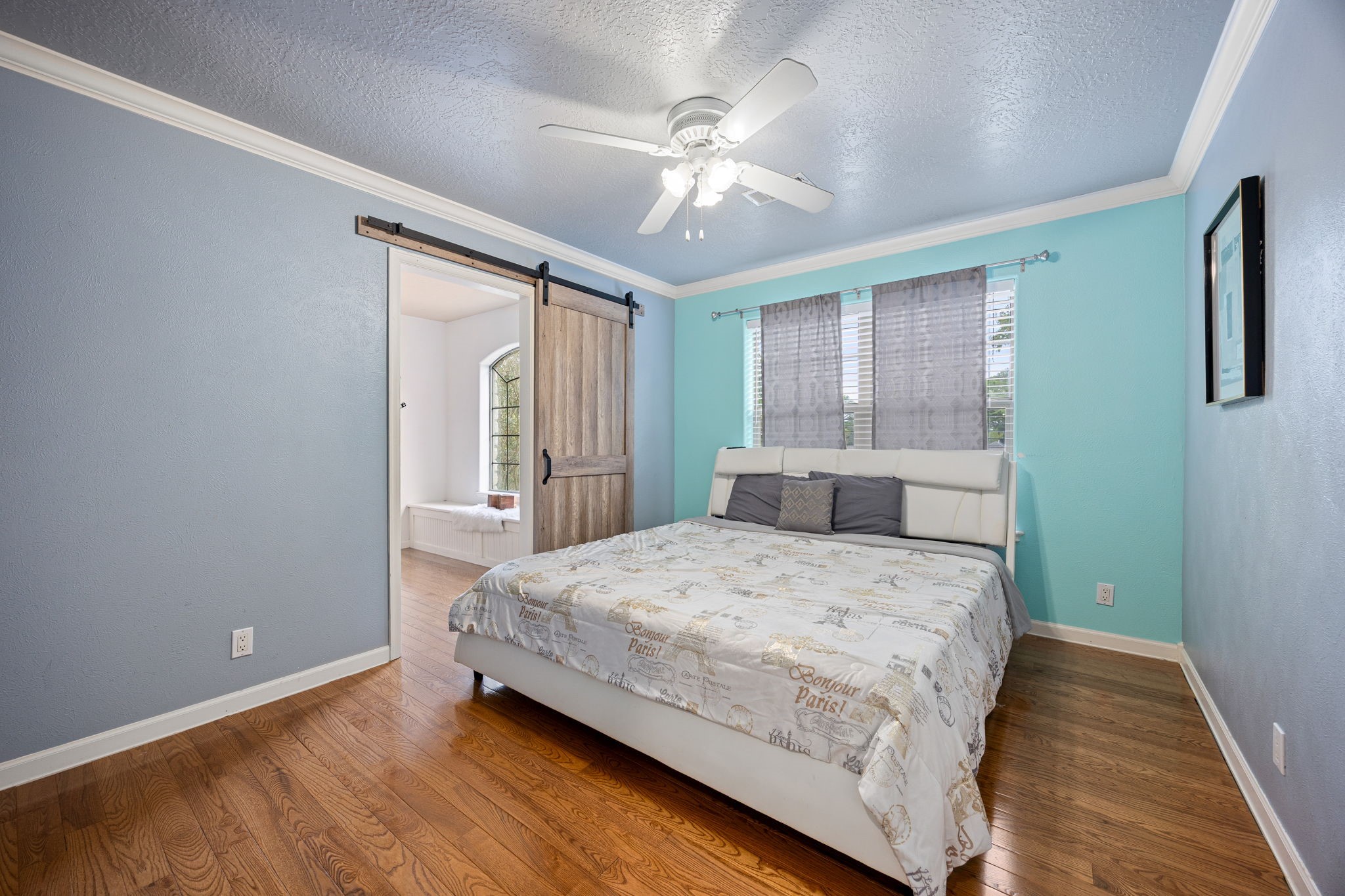 21427 Tophill Drive Spring, TX 77388 - Photo 34 of 50 a bedroom with a large bed and a chandelier