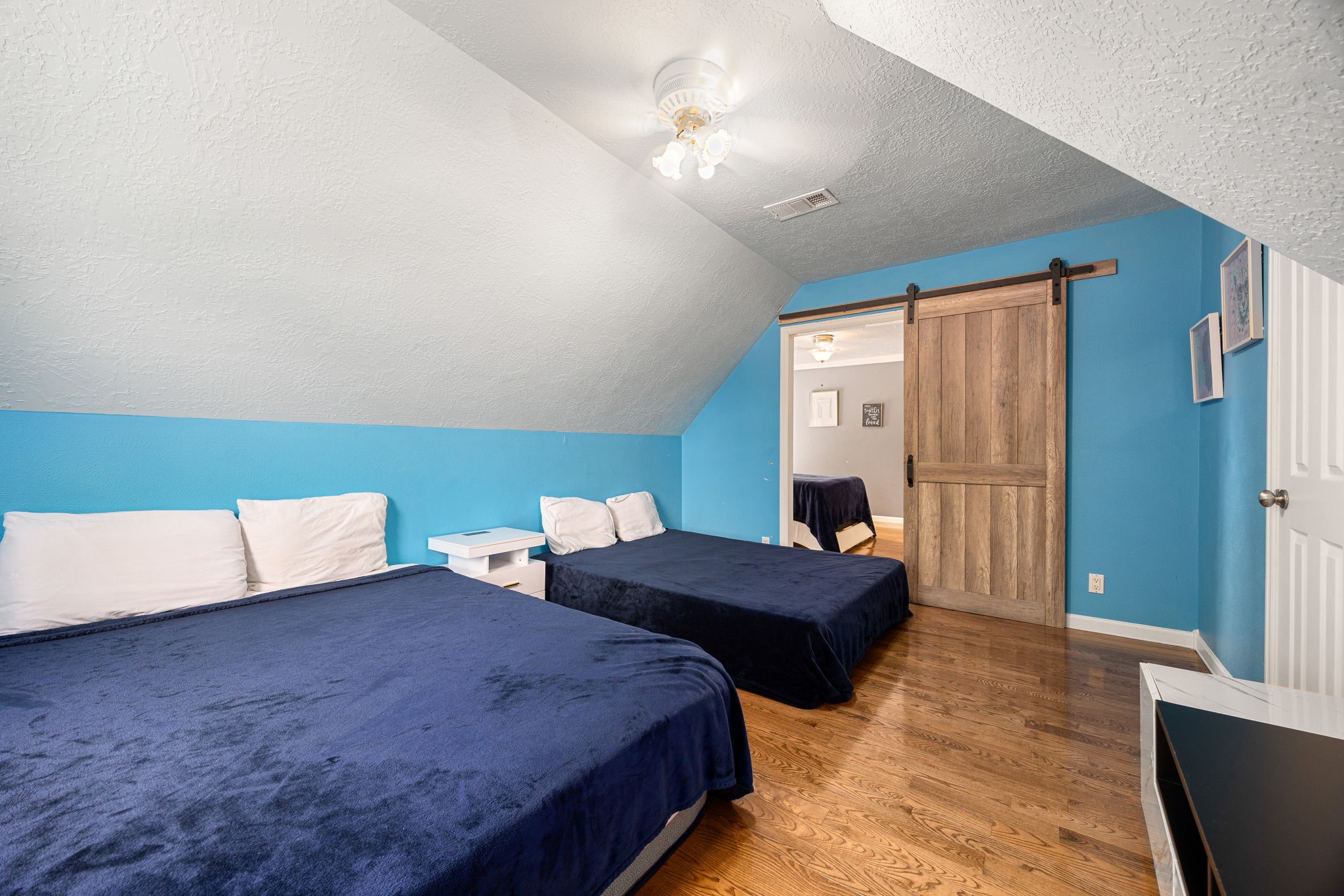 21427 Tophill Drive Spring, TX 77388 - Photo 39 of 50 a bedroom with two beds and a chandelier