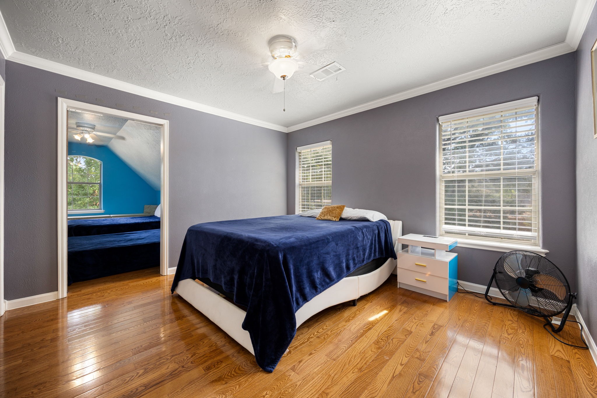 21427 Tophill Drive Spring, TX 77388 - Photo 40 of 50 a spacious bedroom with a bed and a chandelier