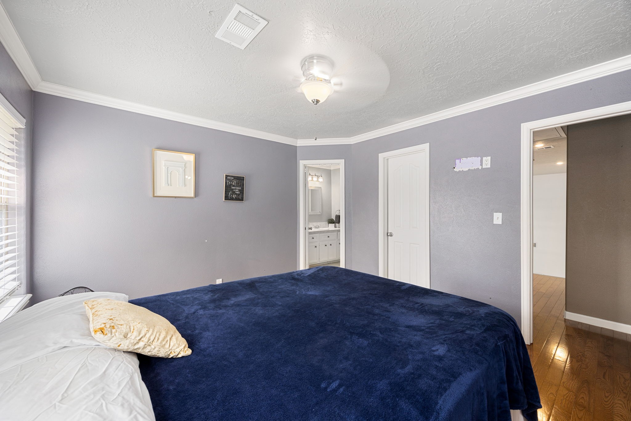 21427 Tophill Drive Spring, TX 77388 - Photo 41 of 50 a bedroom with a bed and a chandelier