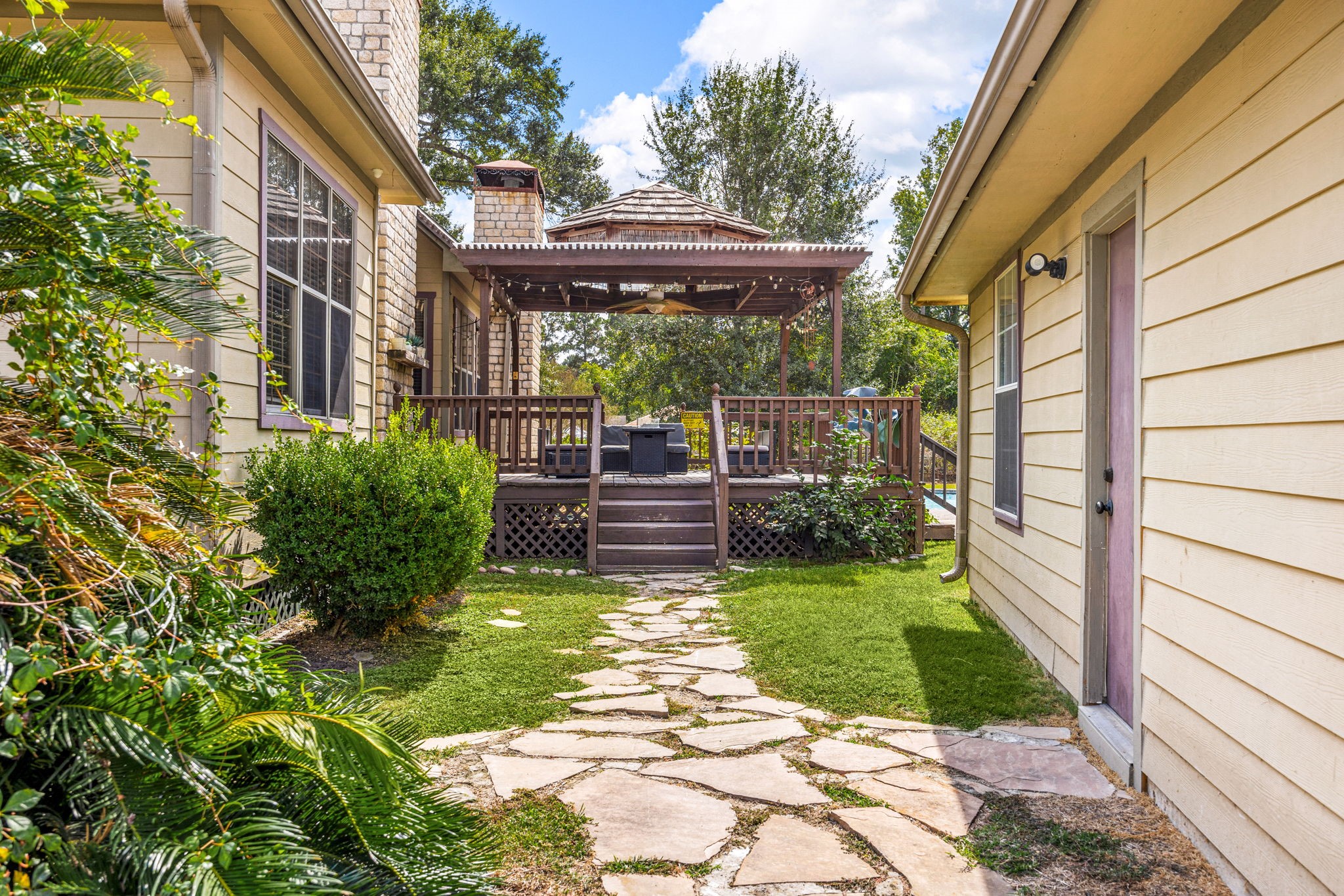 21427 Tophill Drive Spring, TX 77388 - Photo 44 of 50 a view of a patio with table and chairs under an umbrella with large trees