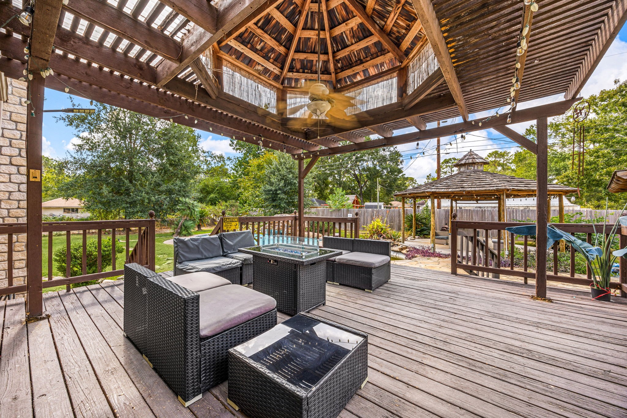 21427 Tophill Drive Spring, TX 77388 - Photo 45 of 50 a view of a patio with couches wooden floor to ceiling window with wooden floor
