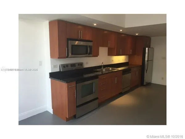 a kitchen with a sink and a microwave