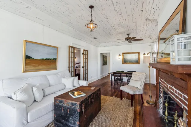 a living room with furniture a window and a fireplace