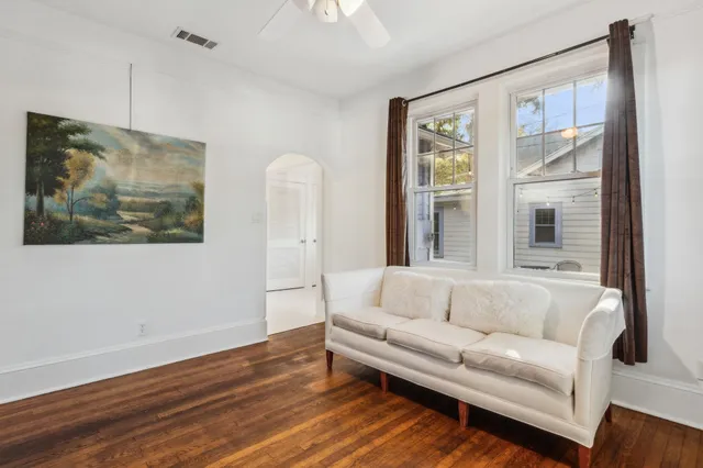 a living room with furniture and a wooden floor