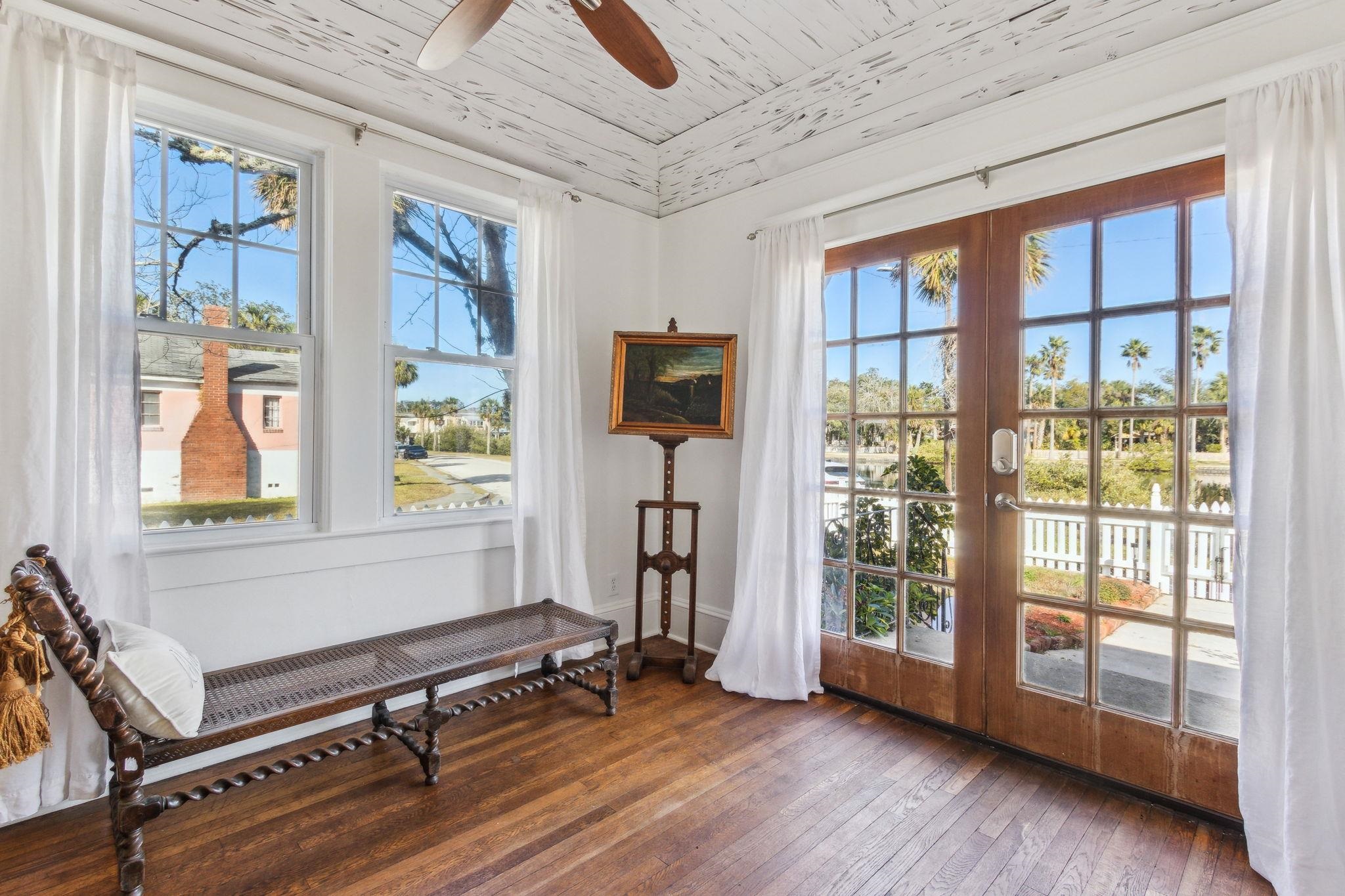 67 Park Place St. Augustine, FL 32084 - Photo 2 of 69 a living room with furniture a flat screen tv and windows