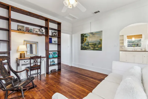 a living room with furniture and wooden floor