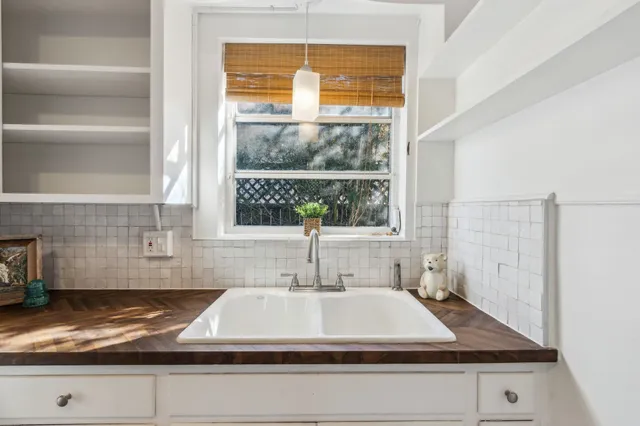 a kitchen with white cabinets and white appliances