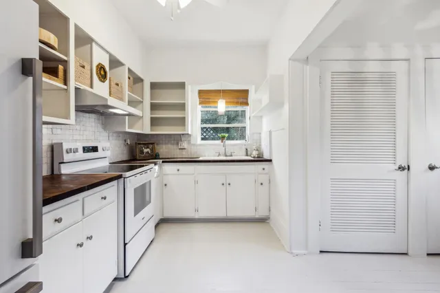 a view of a kitchen with furniture and wooden floor