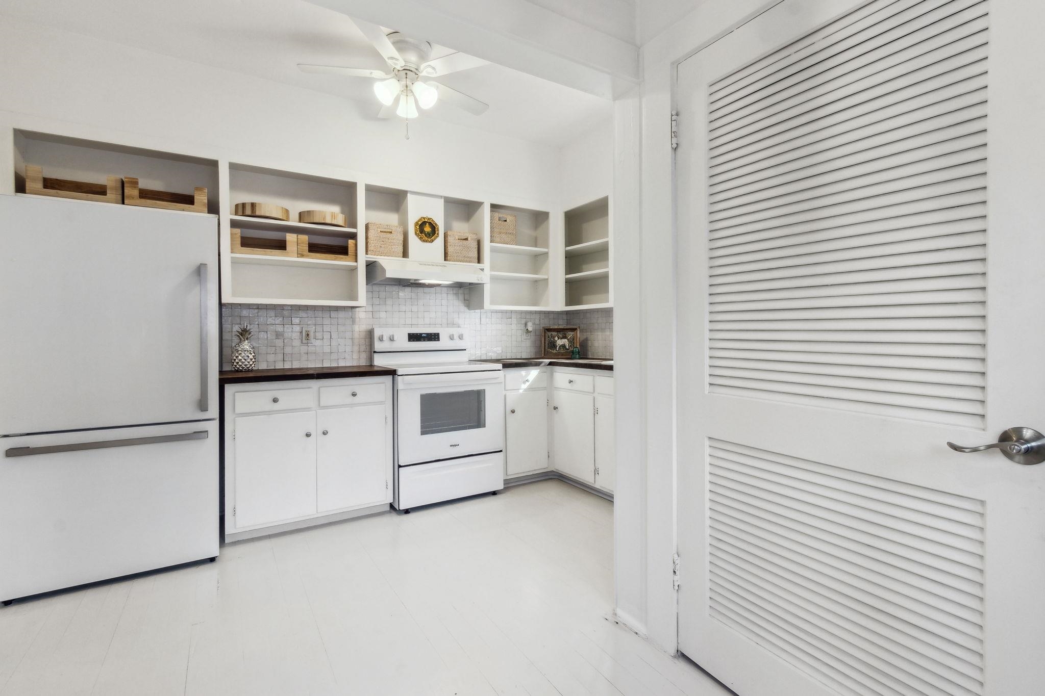 67 Park Place St. Augustine, FL 32084 - Photo 25 of 69 a kitchen with white cabinets and white appliances