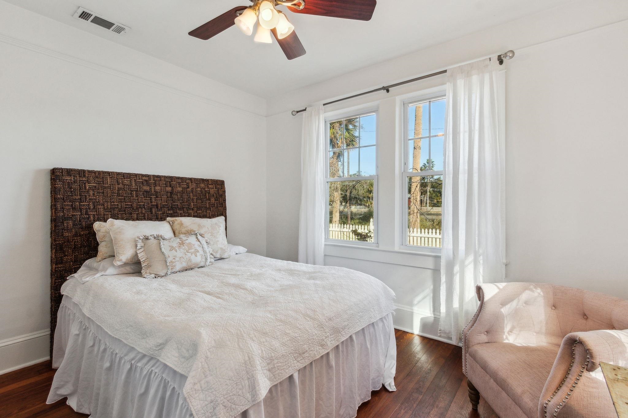 67 Park Place St. Augustine, FL 32084 - Photo 35 of 69 a bedroom with a bed and a chandelier