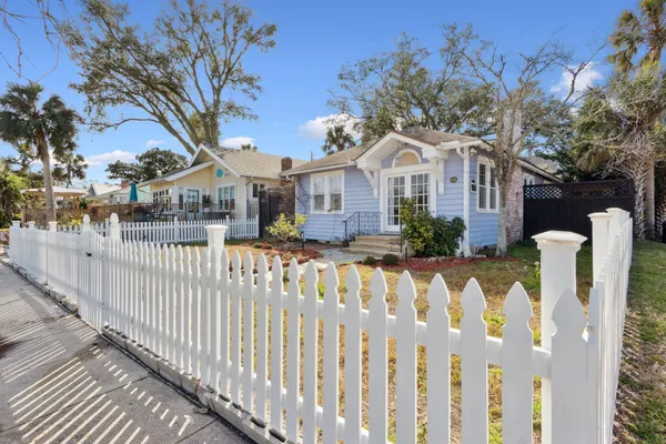 a front view of house with yard covered with green space