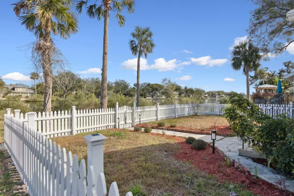a view of a swimming pool with a garden and patio
