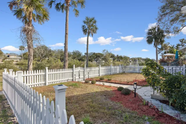 a view of a swimming pool with a garden and patio